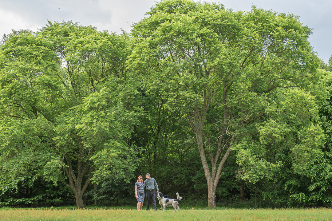 couple with dog during outdoor maternity session in norfolk