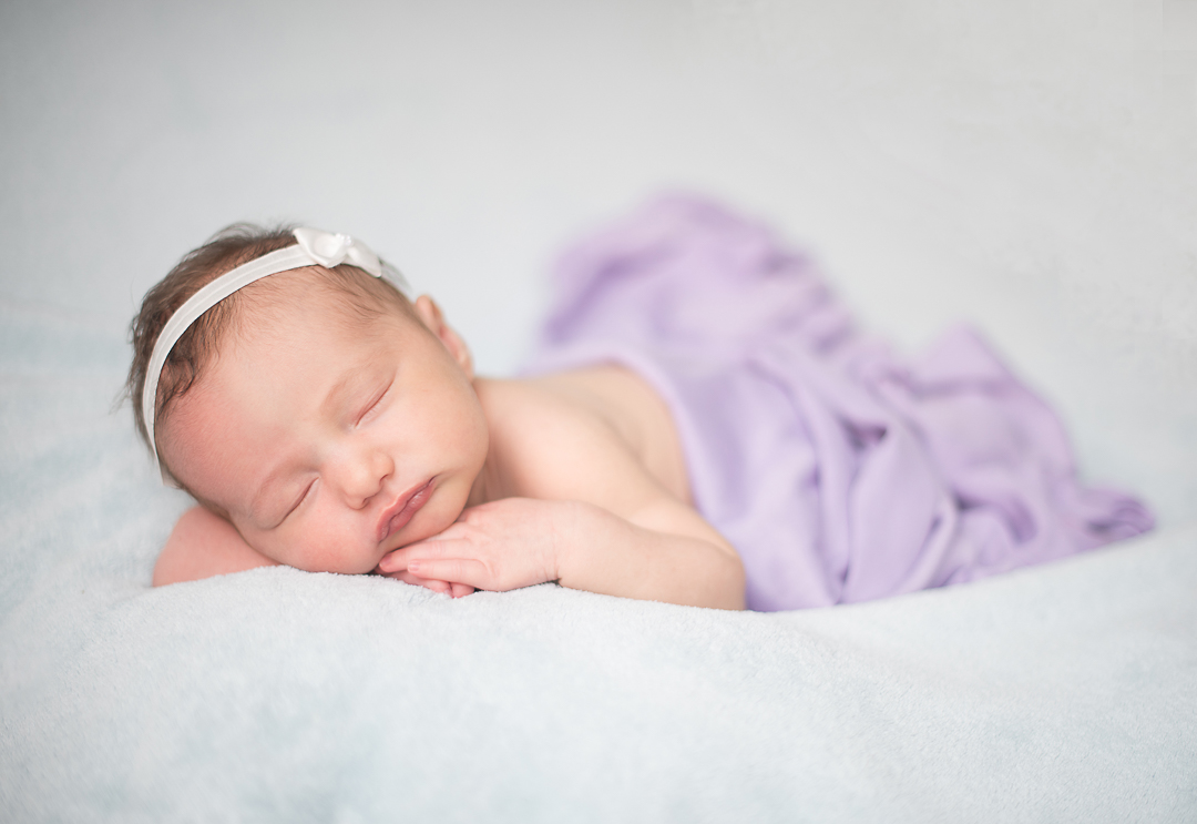 newborn baby on blanket asleep during newborn photography session with Alison Armstrong