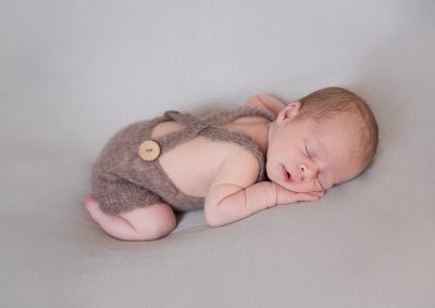 newborn baby asleep laying on tummy during norfolk family session