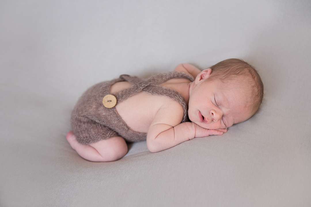 newborn baby asleep laying on tummy during norfolk family session