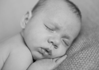 close up of baby in black and white during newborn session in norwich