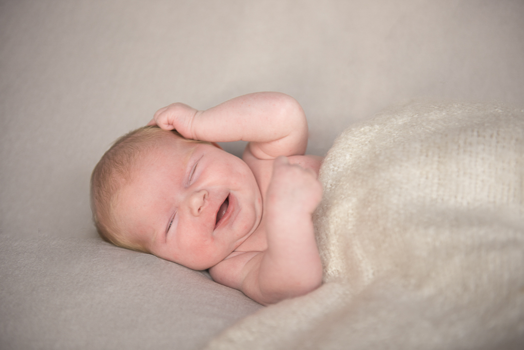 newborn baby laughing during photography session in Norfolk