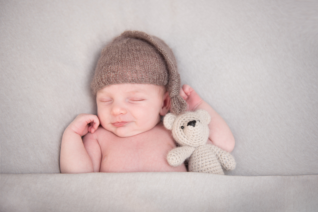 baby sleeping and smiling during photography session in Norfolk with Alison Armstrong