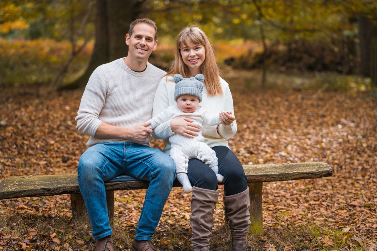 Family sitting on bench during family photography session in Norfolk