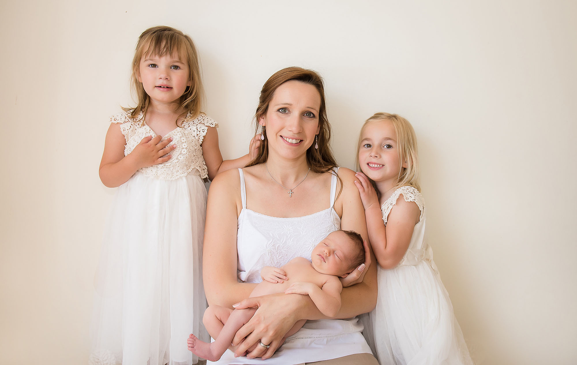 newborn baby mum and sisters at Norfolk newborn in home session
