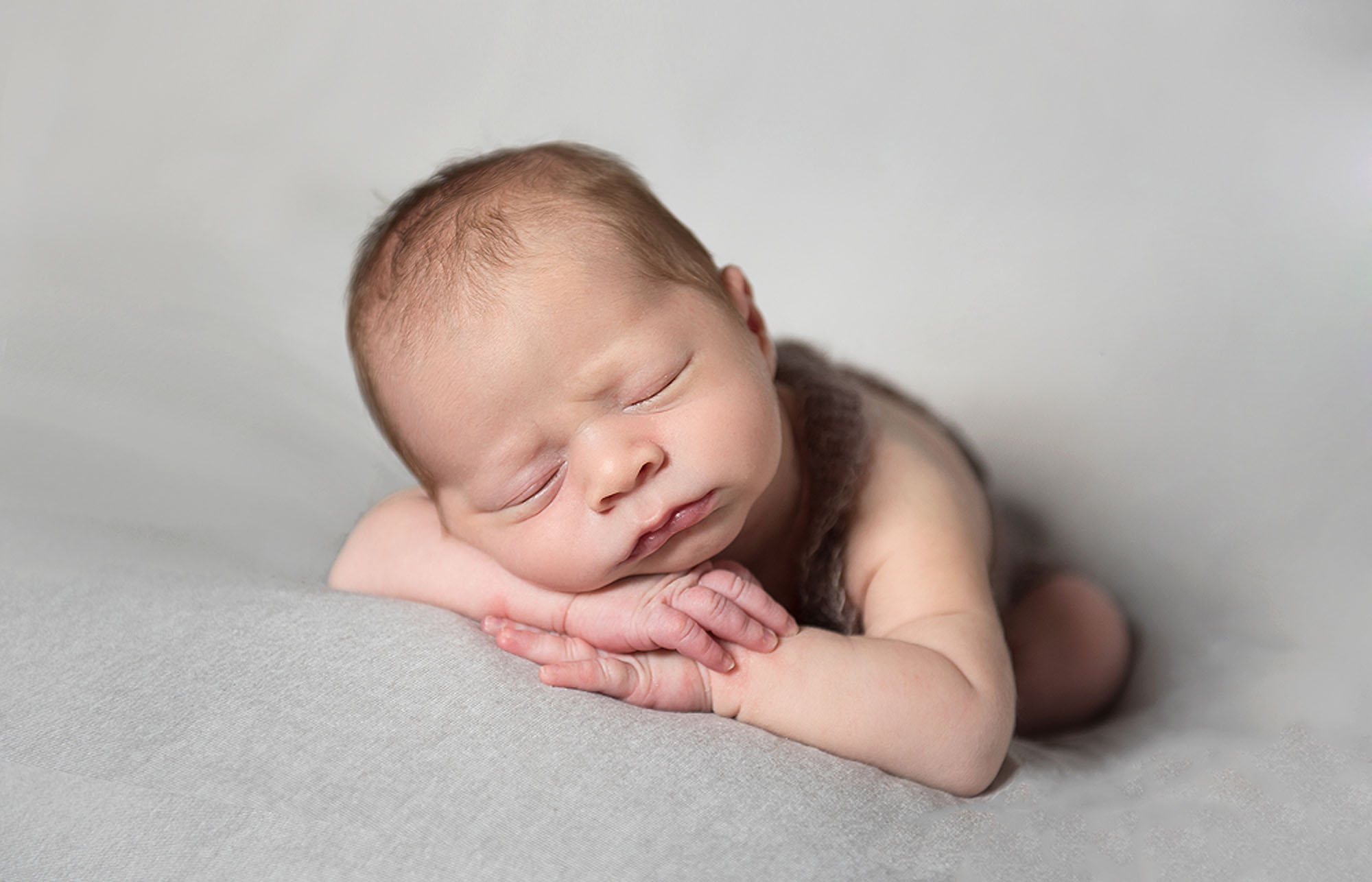Baby looking sleepy at Newborn photography session in norfolk