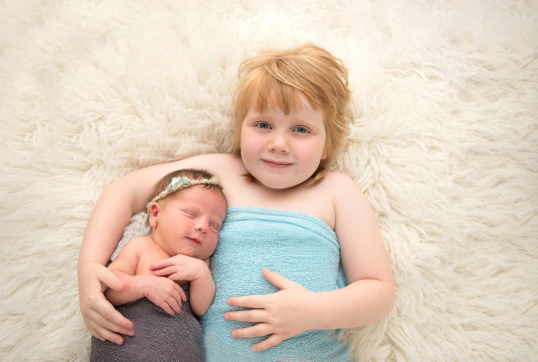 Sister and newborn baby during Norfolk portrait session with Alison Armstrong